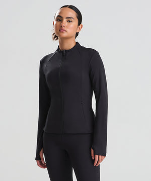 Lifestyle photo of the Women’s Recycled Tech-Zip Jacket in Jet Black