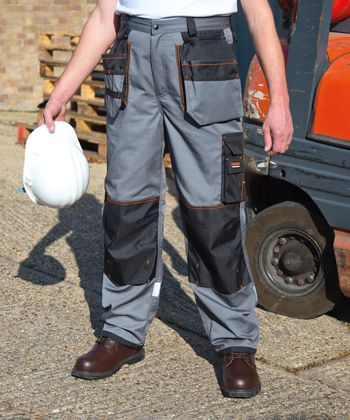 Lifestyle photo of the Work-Guard X-Over Holster Trousers in Grey/Black